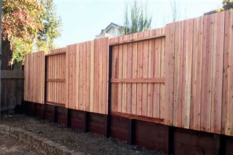 What is the difference between a fence and a retaining wall?