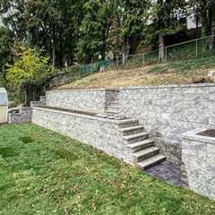 How Natural Stone Retaining Walls Protect Pools on Sloped Properties