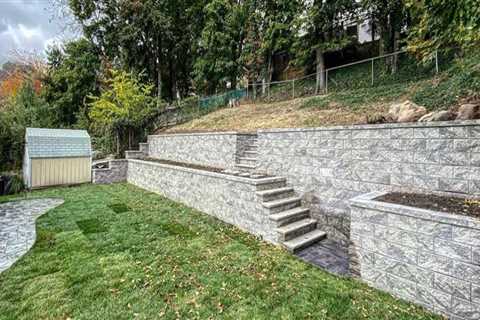 How Natural Stone Retaining Walls Protect Pools on Sloped Properties